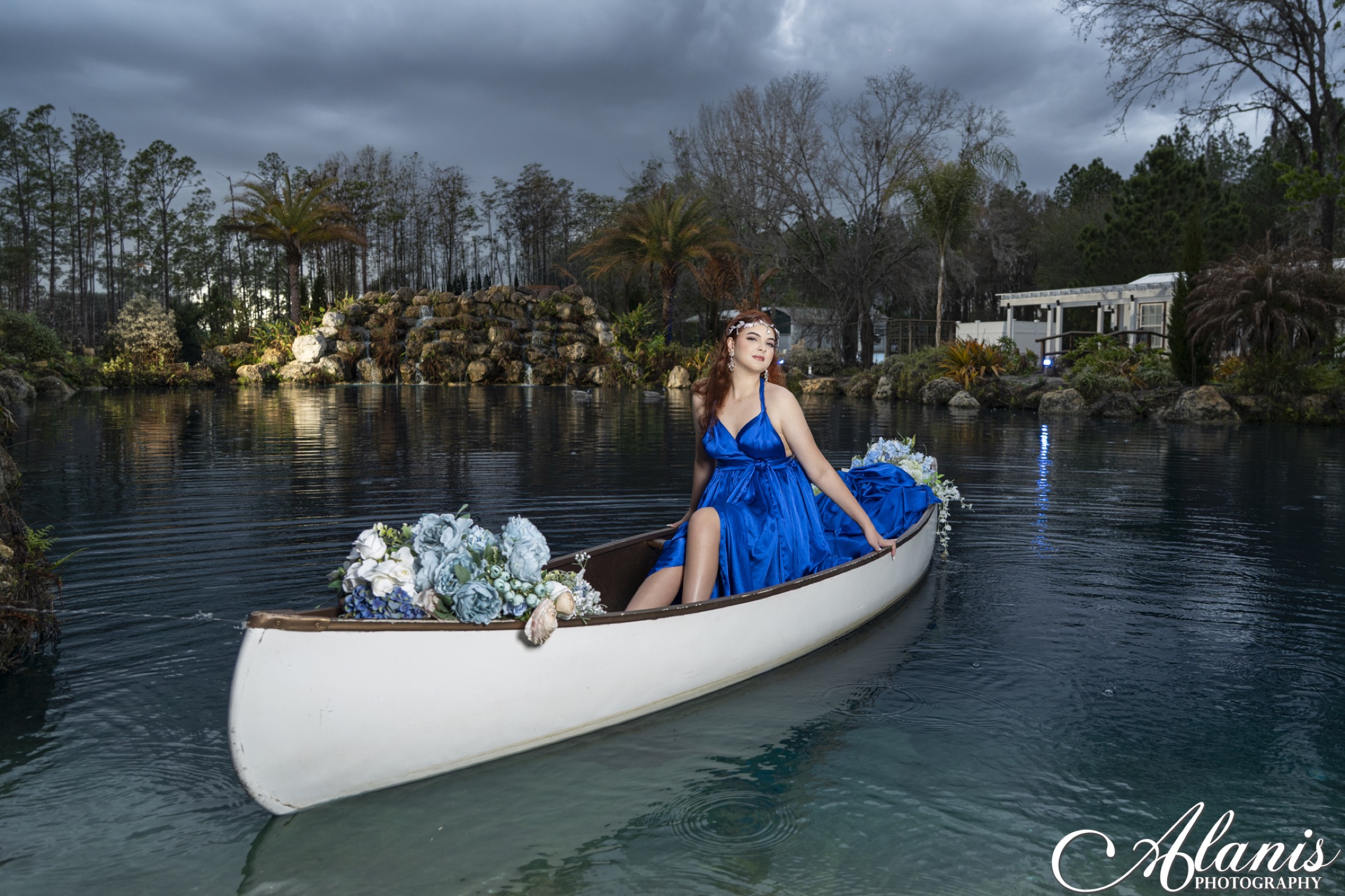 Quinceañera in a blue gown aboard a boat